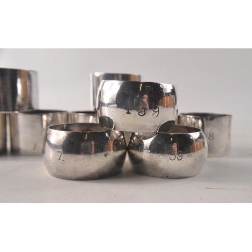 127 - Selection of 11 white metal napkin rings. 3 embossed RAF, 7 embossed  