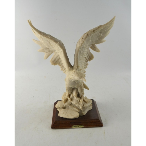 148 - Fine quality Bald Eagle in flight resin statue by artist A Bolcari set on a wooden plynth