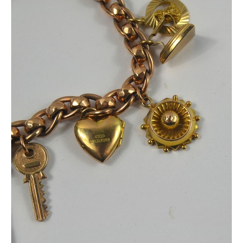 160 - A nice gold charm bracelet, filled with charms. Chain is 375 stamped gold with 12 charms, one a moun... 