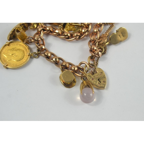 160 - A nice gold charm bracelet, filled with charms. Chain is 375 stamped gold with 12 charms, one a moun... 