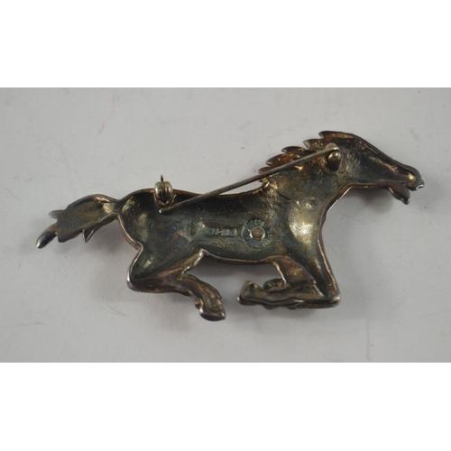 43 - From a marvellous collection of jewellery A white metal quality galloping horse with makers marks ... 