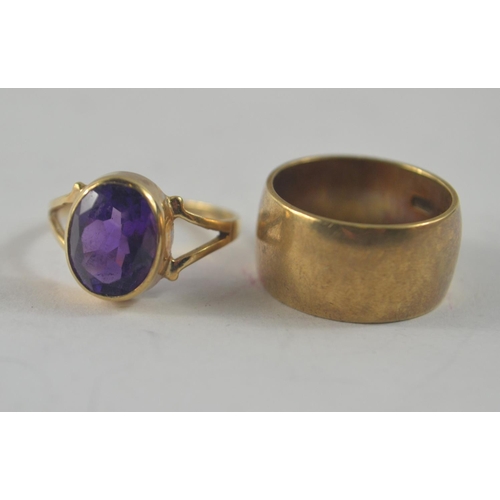 45 - Two 9ct rings. One thick band (9mm across!, size J) other set with large purple stone (size K/L)