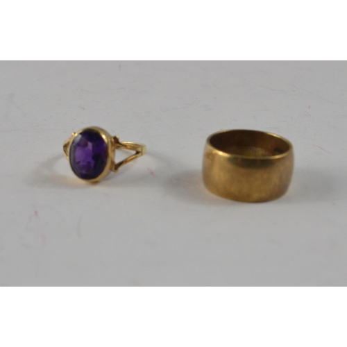 45 - Two 9ct rings. One thick band (9mm across!, size J) other set with large purple stone (size K/L)