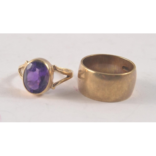 45 - Two 9ct rings. One thick band (9mm across!, size J) other set with large purple stone (size K/L)