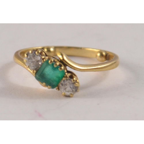 72 - STUNNING !!Three stone emerald and diamond cross over, and two old cut brilliant diamonds in claw se... 