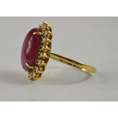 73 - Oval Cabochon ruby and diamond cluster ring, tested as 18ct 15.9 x 9.7 x 6.88mm 7.31g gross weight r... 