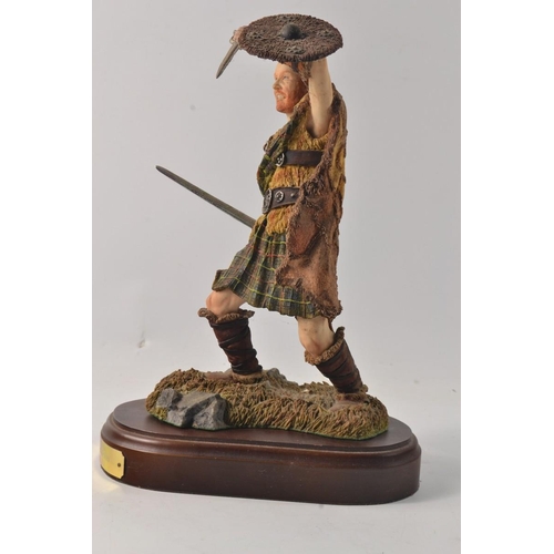 286 - A Holland Studio Crafed  Sworded Highlander on a wooden plynth