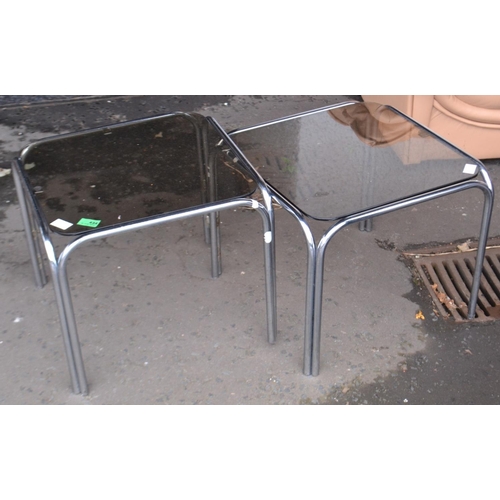 434 - A pair of tubular stainless steel smoked glass topped side tables 1.5ft square 1ft height approx