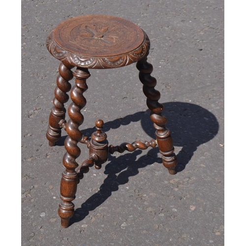 495 - An unusual cEdwardian twisted leg three legged stool with carved decoration on seat top