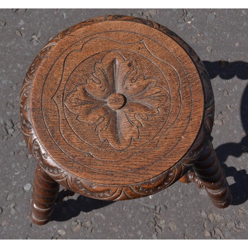 495 - An unusual cEdwardian twisted leg three legged stool with carved decoration on seat top