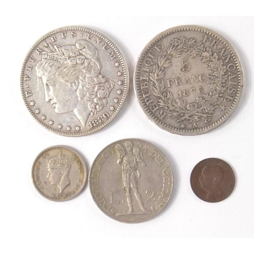 81 - Collection of mainly silver coins to include an1873 5 francs silver coin, an American One Dollar 188... 