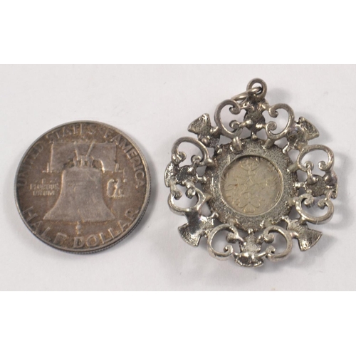 6 - A white metal mounted with a sixpence set in a SCOTTISH THISTLE pendant, also included is an America... 