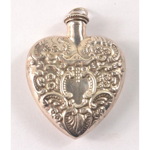 42 - A Vintage heart shaped silver 925 stamped repousse pendant perfume bottle with tiny screw top lid wi... 