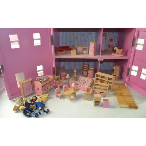 253 - Nice dolls house with some furniture in pink