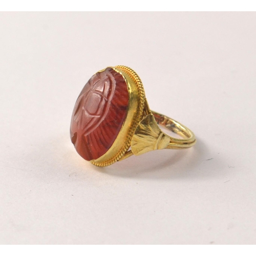 13 - CARNELIAN Dress ring with oval cabouchon cut stone, Hallmark indistinct and valued as 22ct gold weig... 