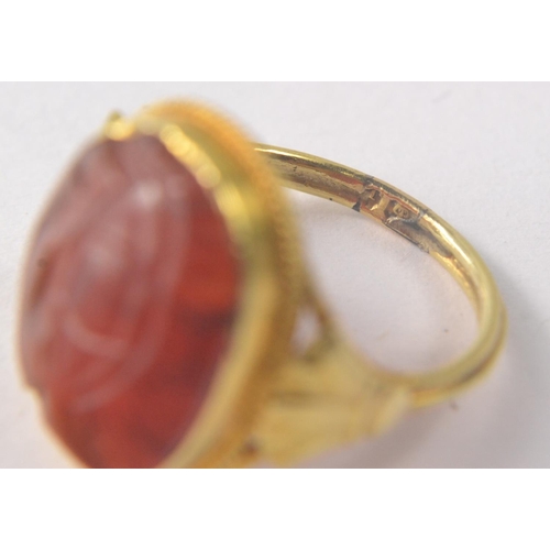 13 - CARNELIAN Dress ring with oval cabouchon cut stone, Hallmark indistinct and valued as 22ct gold weig... 