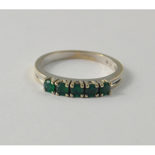 24 - 750 stamped gold ring. Emerald five round faceted cut stones 3.1g gross [size M ]