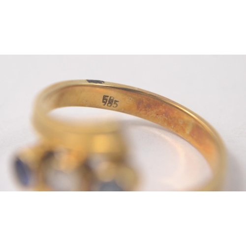 8 - 585 stamped gold ring set with 2 blue stones and 1 clear stone