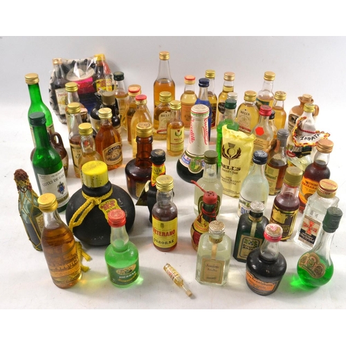 181 - A basket FULL of miniature whiskies etc to include GRANTS, BELLS, GLAYVA ISLANDER etc etc