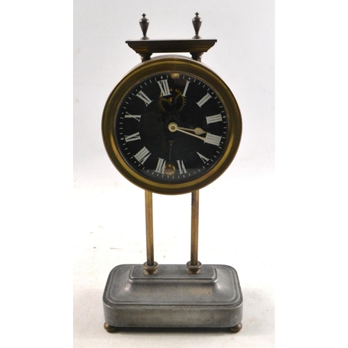 42 - An interesting mantle clock with brass Body and gun metal base