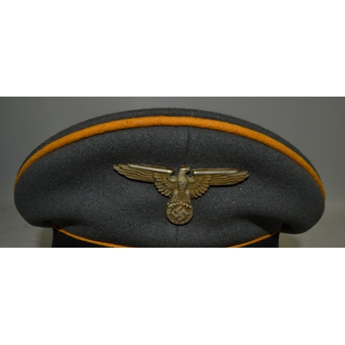 31B - Waffen - SS NCO's peaked visor cap with yellow piping indicating it was for the calvary. Pinned into... 