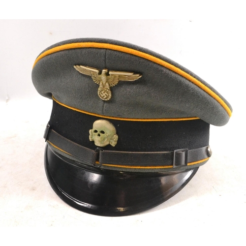 31B - Waffen - SS NCO's peaked visor cap with yellow piping indicating it was for the calvary. Pinned into... 