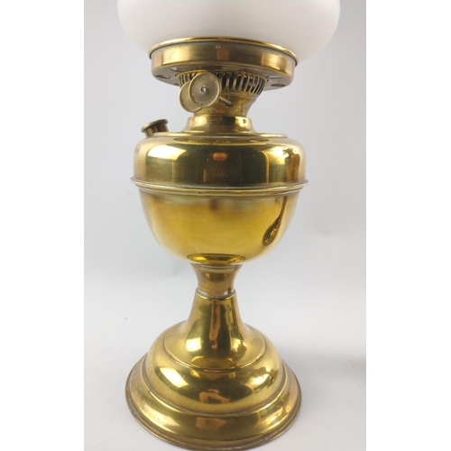 230 - Two brass-effect oil lamps, one with shade both with chimneys approx. 50cm each.#288