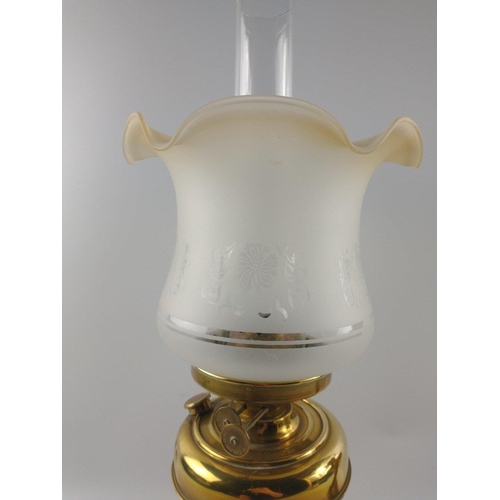 230 - Two brass-effect oil lamps, one with shade both with chimneys approx. 50cm each.#288