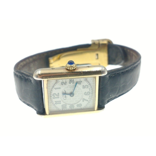 49 - CARTIER Ladies Tank watch, 18ct yellow gold on 925 silver with blue cabachon on winder. [ Watch in w... 