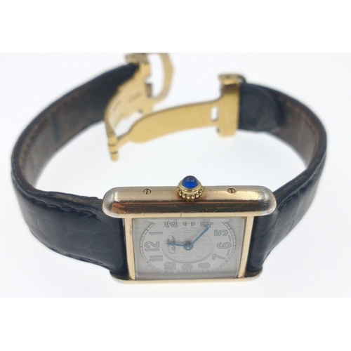 49 - CARTIER Ladies Tank watch, 18ct yellow gold on 925 silver with blue cabachon on winder. [ Watch in w... 