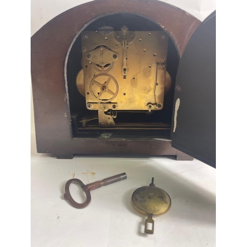 55 - A mantelpeice CLOCK, still retaining its key, stands 22cm high.#66