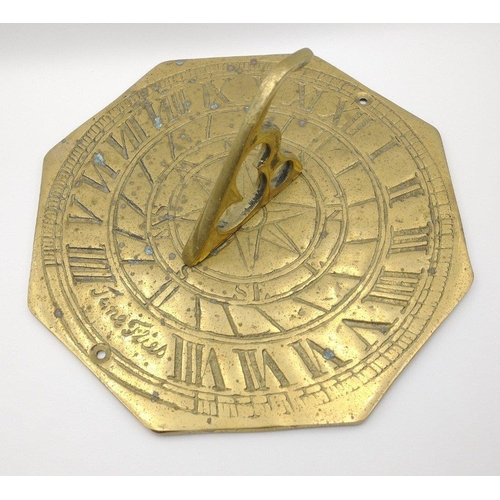 59 - A BRASS SUNDIAL (19cm width) with Roman numerals and 'Time Flies' inscribed.#70