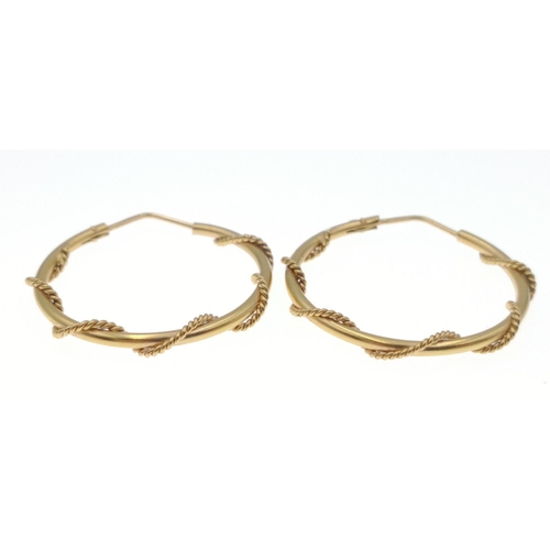 18 - Two pairs of hoop earrings one 750 stamped(faint stamp) purchased in Saudi Arabia, weight 6.5g appro... 