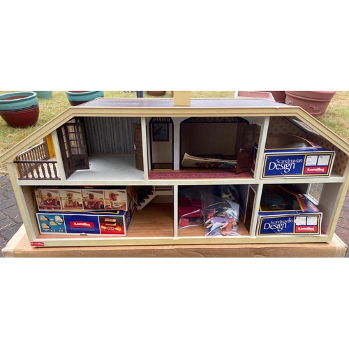 335A - A large LUNDY MAKE  DOLLS HOUSE loaded with furniture dolls etc length 90cm x width 28cm x 38 cm hei... 