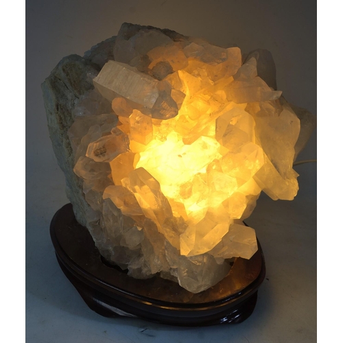 482 - A large STUNNING SPECIMEN piece of ROCK CRYSTAL thought to be from BRAZIL, ON A BASE, which lights-u... 