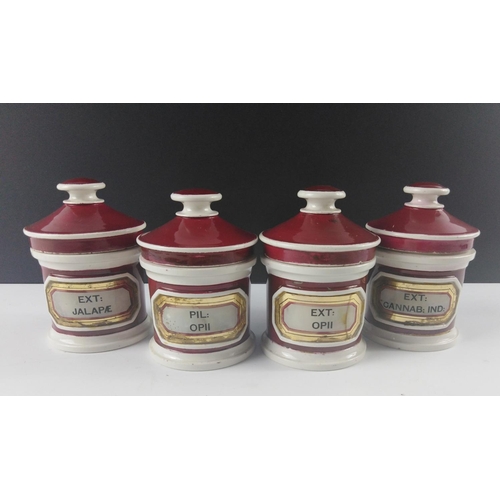 100 - SET OF FOUR Small cEdwardian Apothecary ceramic lidded jars in traditional maroon, stamped to base Y... 