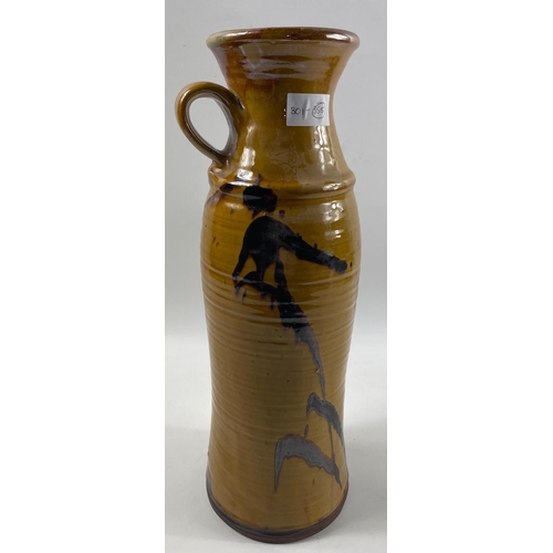 101 - A large ceramic handled POT by CAROLE GLOVER in yellow and brown height 43cm x 11cm diameter at rim#... 