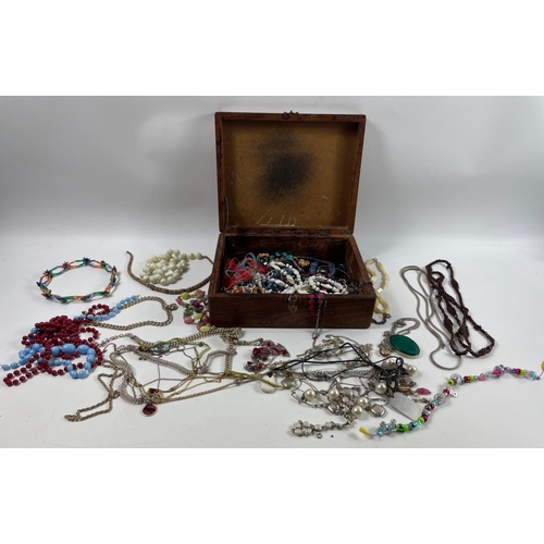 18 - A wooden box (28 x 23 x 9cm) of costume jewellery to include a colourful mixture of beaded necklaces... 