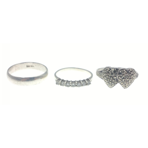 8 - A trio of silver rings to include one stamped silver, and two stamped 925, a wedding band size R, a ... 