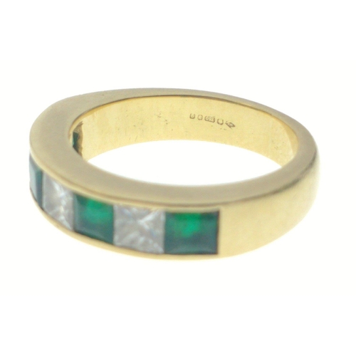 10 - A SUBSTANTIAL 750 hallmarked yellow gold RING size O/P set with four large cut EMERALDS 4mm length a... 