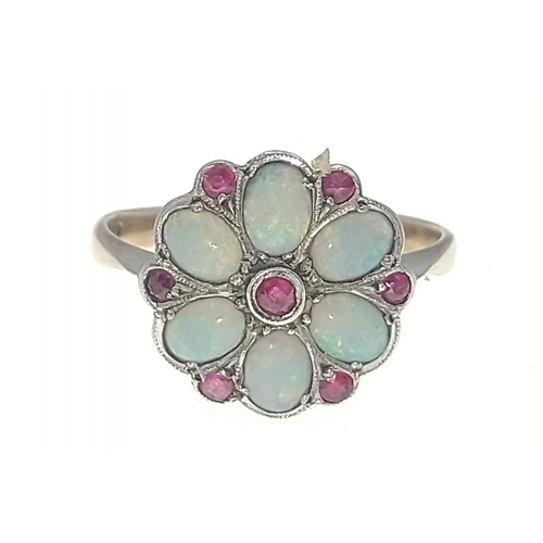 12B - A 9ct gold opal ring with 6 opals and 7 red stones in a flower-head pattern, size M/N gross weight 2... 