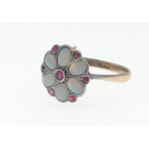 12B - A 9ct gold opal ring with 6 opals and 7 red stones in a flower-head pattern, size M/N gross weight 2... 