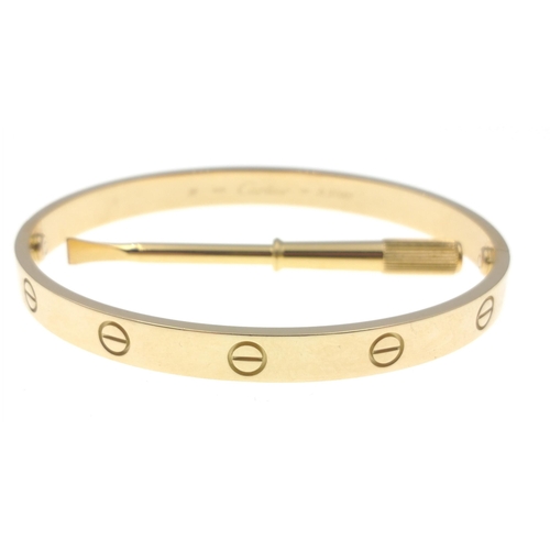 20 - CARTIER 750 stamped yellow gold oval shaped 'LOVE BRACELET' with original key, dimensions 6.5cm x 5.... 