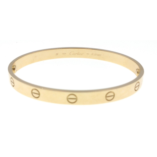 20 - CARTIER 750 stamped yellow gold oval shaped 'LOVE BRACELET' with original key, dimensions 6.5cm x 5.... 