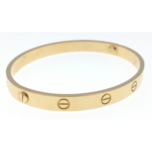 20 - CARTIER 750 stamped yellow gold oval shaped 'LOVE BRACELET' with original key, dimensions 6.5cm x 5.... 