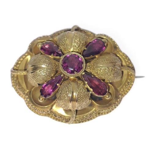 44 - A VICTORIAN  'yellow metal' oval BROOCH with a leaf and flower bud design, set with 5 amethysts - BE... 