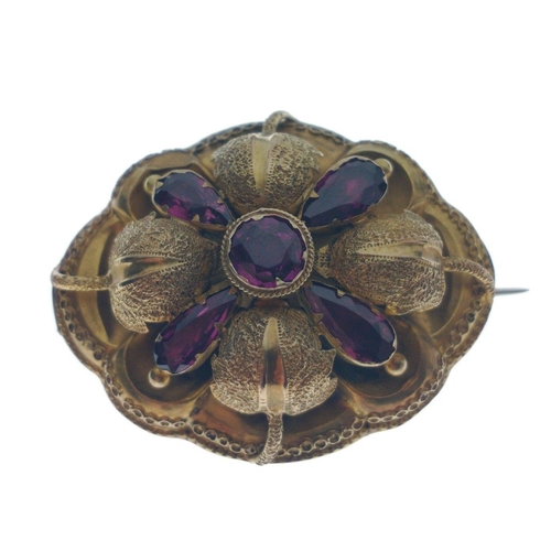 44 - A VICTORIAN  'yellow metal' oval BROOCH with a leaf and flower bud design, set with 5 amethysts - BE... 