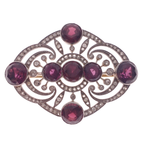 51 - ORNATE STUNNING ART DECO DESIGN! An unmarked diamond and garnet set BROOCH, with 7 round faceted gar... 