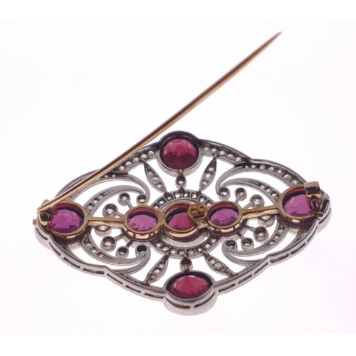 51 - ORNATE STUNNING ART DECO DESIGN! An unmarked diamond and garnet set BROOCH, with 7 round faceted gar... 