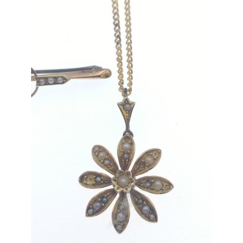 69 - BEAUTIFUL!An early 20th century 9ct stamped yellow gold floral form PENDANT with seed pearls and a c... 